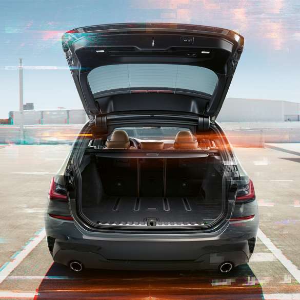 BMW 3 Series Touring, rear shot with open tailgate BMW 3 Series Touring, rear shot with open tailgate on parking lot in urban environment