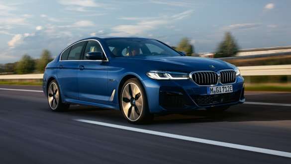 BMW 5 Series Sedan Plug-in hybrid 2021 G30 three-quarter front view driving BMW 5 Series Sedan Plug-in hybrid 2021 G30 three-quarter front view driving on the street