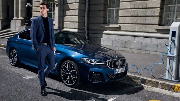 BMW 5 Series Sedan Plug-in hybrid 2021 G30 three-quarter front view charging BMW 5 Series Sedan Plug-in hybrid 2021 G30 three-quarter front view charging with model