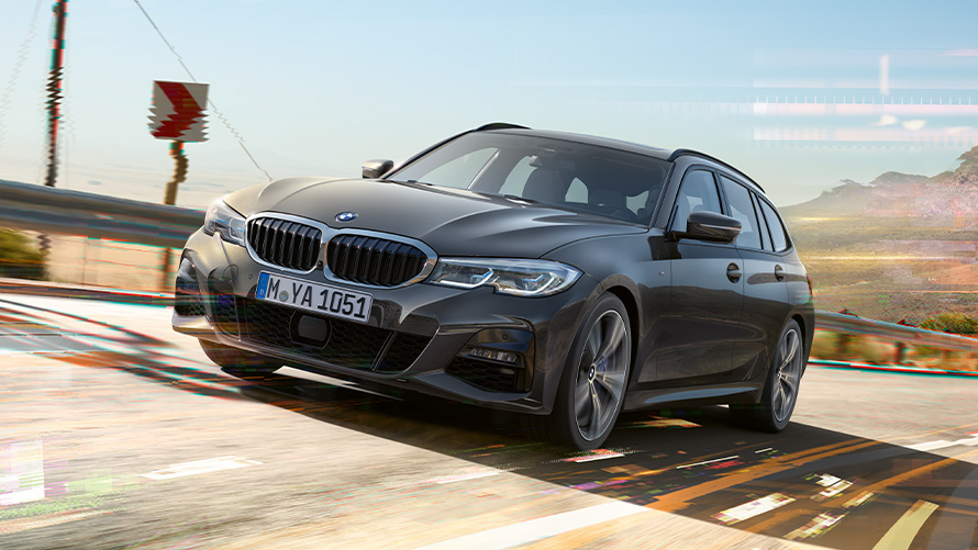 BMW 3 SeriesTouring, (G21), dravite grey, three-quarter front shot BMW 3 SeriesTouring, (G21), dravite grey, three-quarter front shot driving in front of rural surroundings
