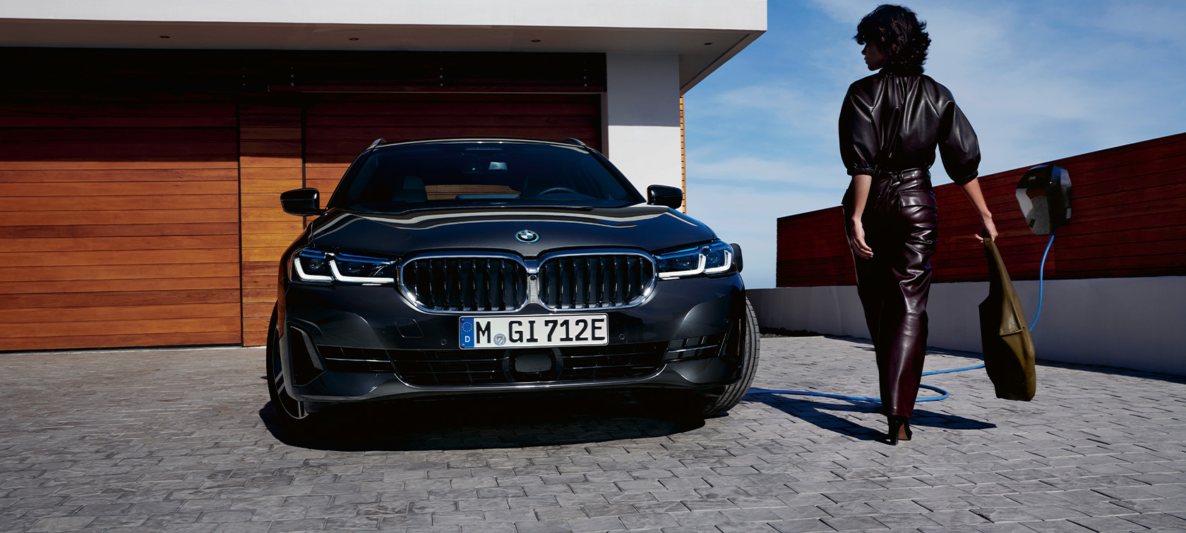 Plug-in hybrid BMW 5 Series Touring 2021 G31 front view charging Plug-in hybrid BMW 5 Series Touring 2021 G31 front view charging with model