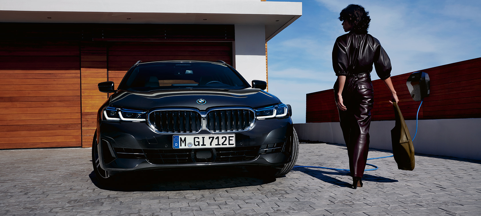 Plug-in hybrid BMW 5 Series Touring 2021 G31 LCI front view charging Plug-in hybrid BMW 5 Series Touring 2021 G31 LCI front view charging with model