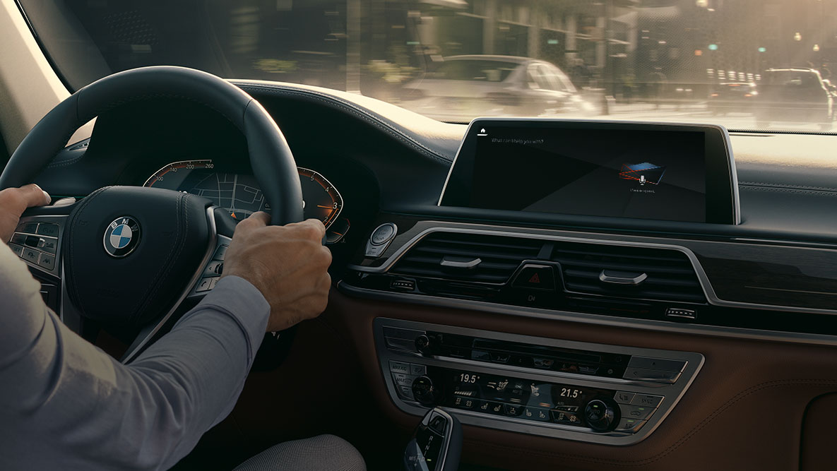 BMW 7 Series Sedan G11 G12 2019 BMW Intelligent Personal Assistant BMW 7 Series Sedan G11 G12 2019 man in cockpit, view of display with BMW Intelligent Personal Assistant