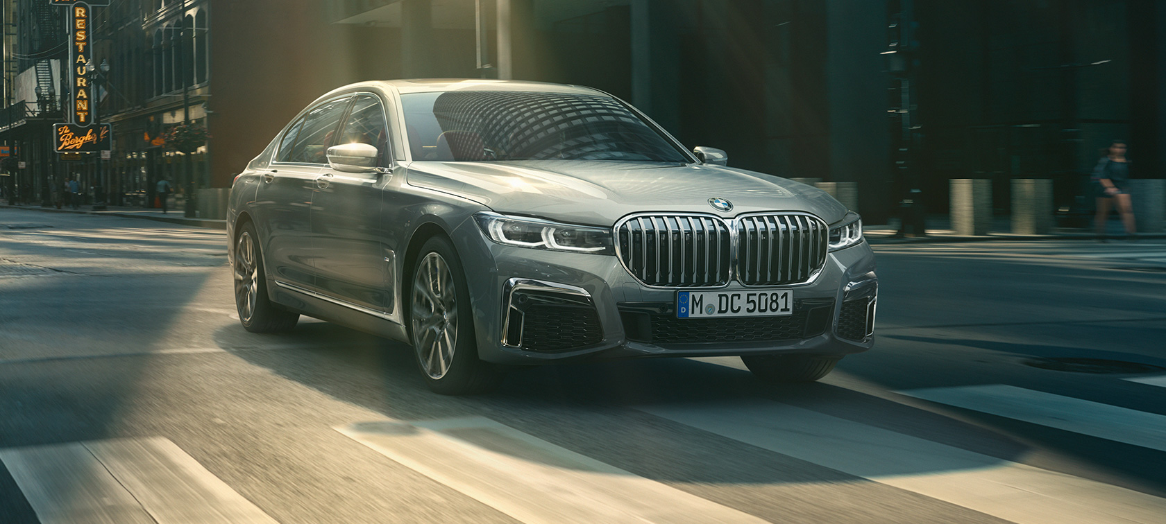 BMW M760Li xDrive Sedan G11 G12 2019 Frozen Dark Silver metallic three-quarter rear view in urban setting BMW M760Li xDrive Sedan G11 G12 2019 Frozen Dark Silver metallic three-quarter rear view in urban setting