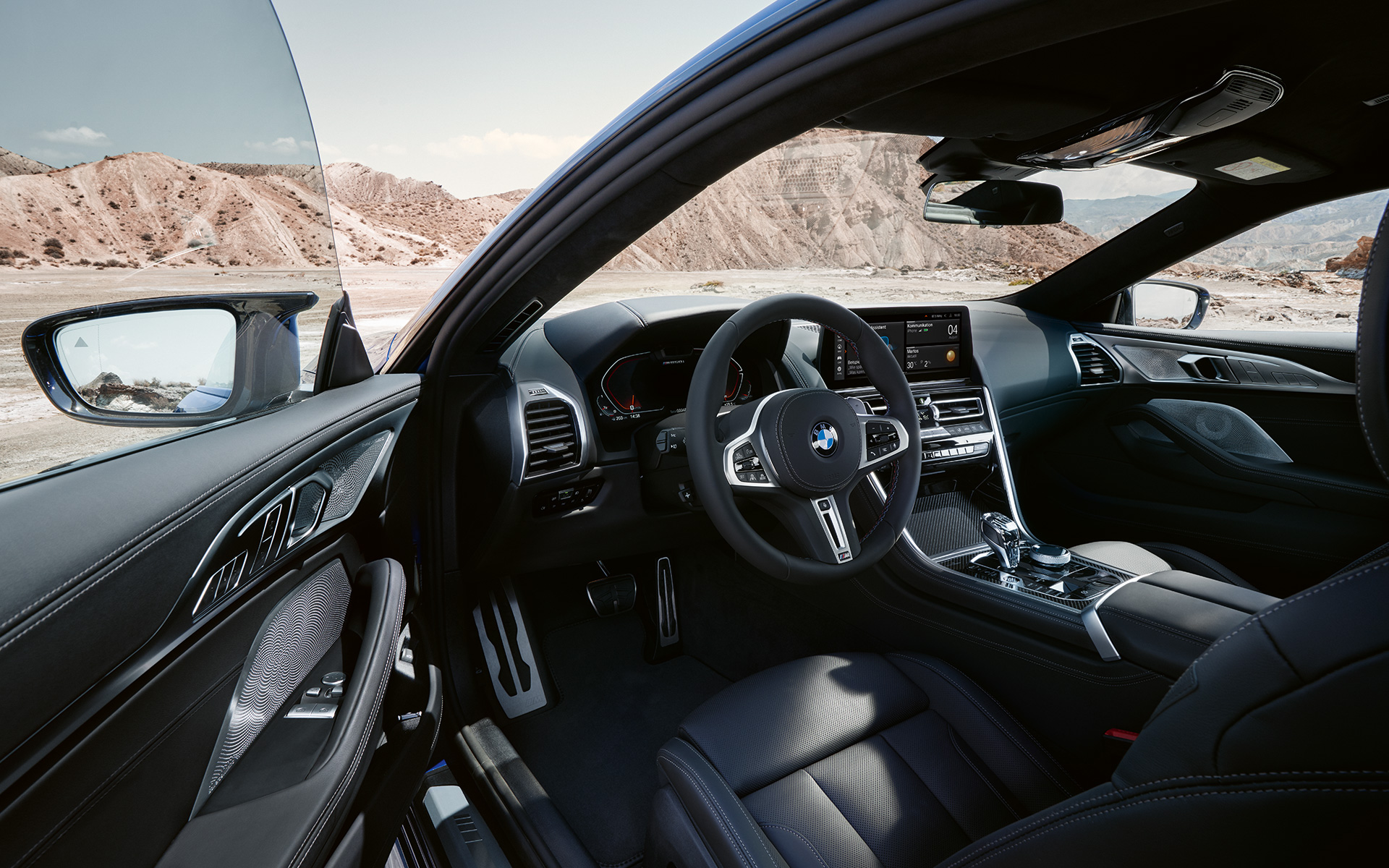 The BMW M850i xDrive Coupé G15 LCI Facelift 2022 Driver-oriented cockpit with M leather steering wheel The BMW M850i xDrive Coupé G15 LCI Facelift 2022 Driver-oriented cockpit with M leather steering wheel with open front door