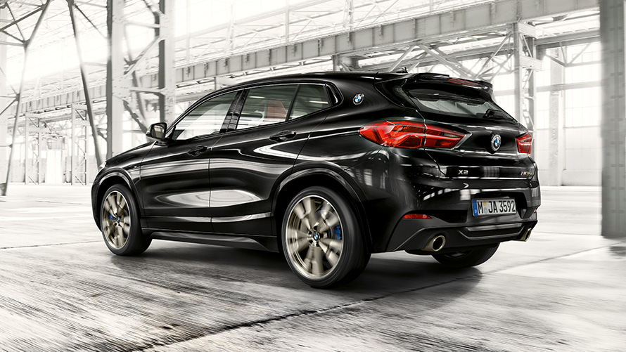 BMW X2 M35i (F39), Black Sapphire metallic, Three-quarter rear view driving BMW X2 M35i (F39), Black Sapphire metallic, Three-quarter rear view driving