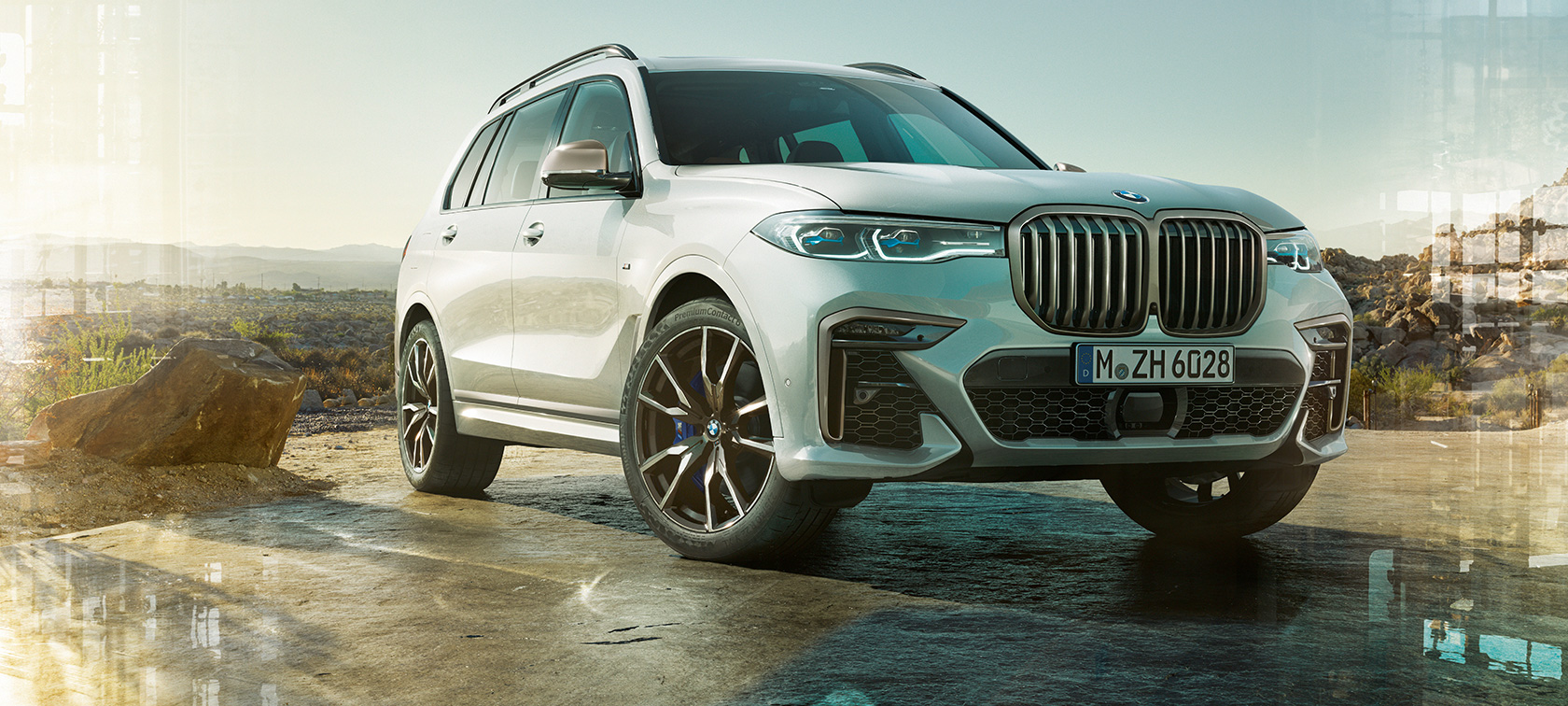 BMW X7 M Automobile G07 2019 three-quarter front view BMW X7 M Automobile G07 2019 Mineral White three-quarter front view standing