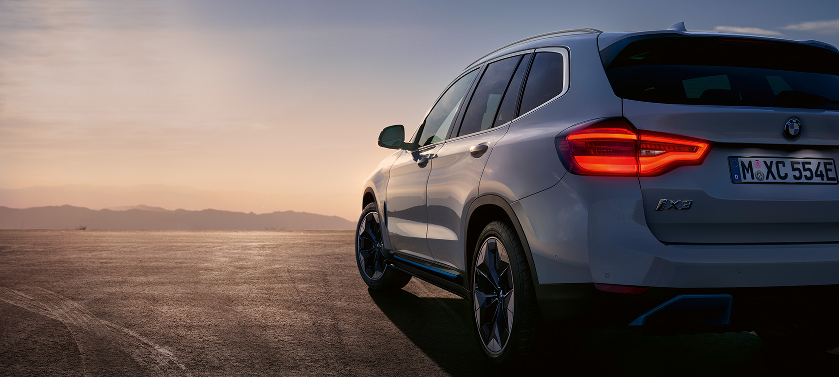 BMW iX3 G08 standing on street BMW iX3 G08 2020 Mineral White metallic three-quarter rear view standing on street