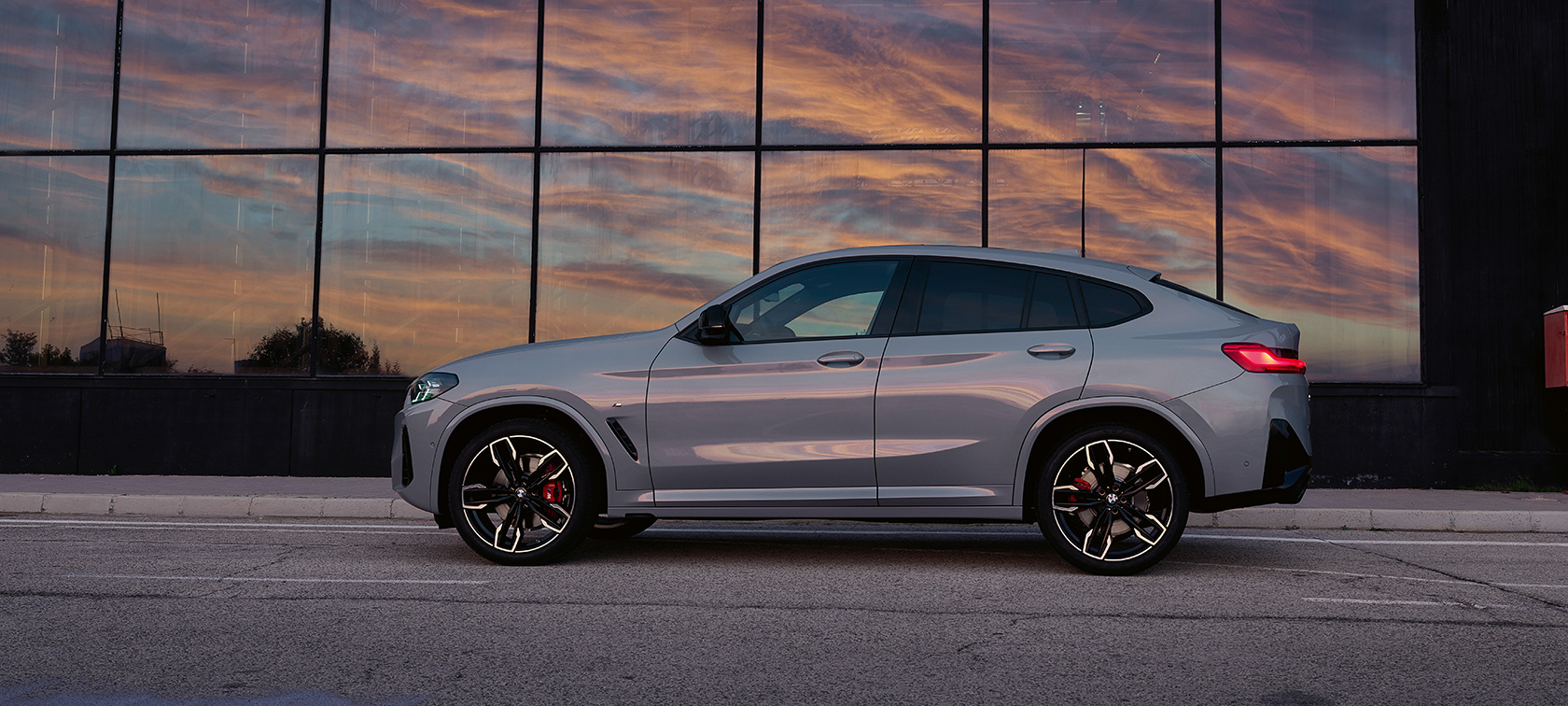 BMW X4 G02 three-quarter rear view driving 2021